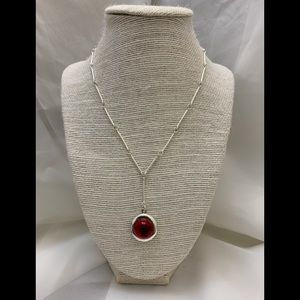 Artistic silver necklaces with red crystal.